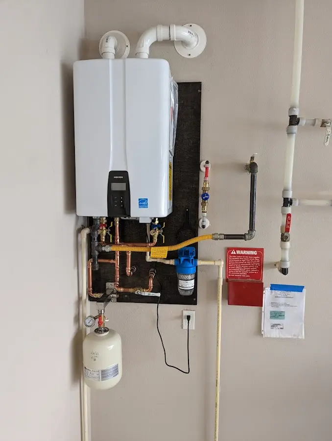 Professional plumber installing copper piping in a Negaunee home